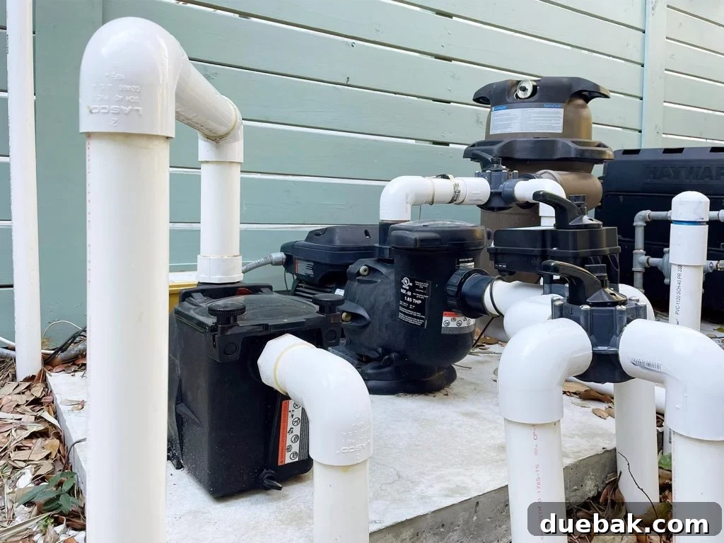 Pool equipment with exposed white PVC pipes