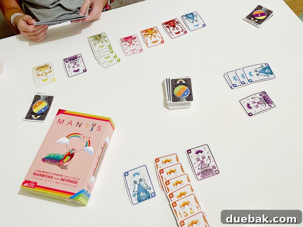 Mantis Colorful Card Game Being Played On Table