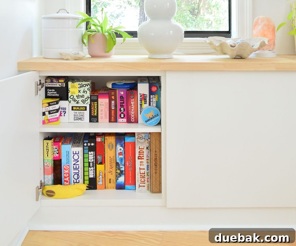 Ikea Besta Cabinet With Door Open Showing Family Board Game Storage