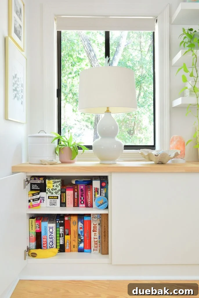 Ikea Besta Cabinet With Door Open Showing Family Board Game Storage