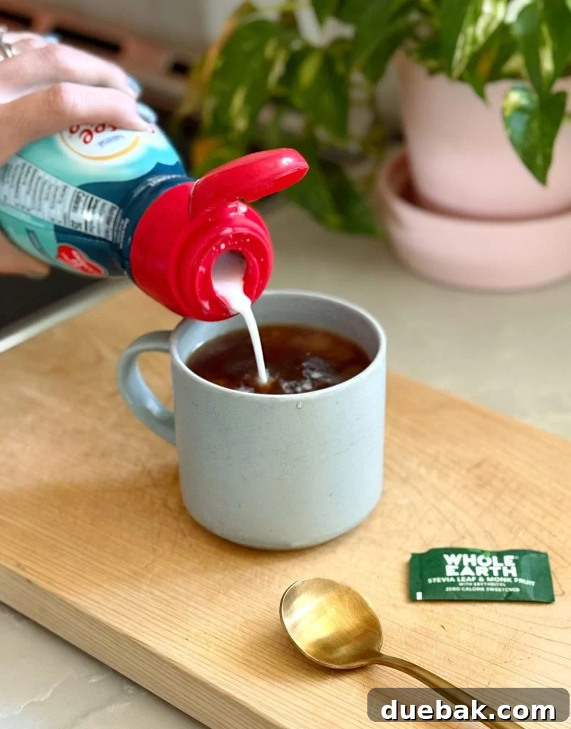 Adding Coconut Creamer To Mug of Pour Over Coffee