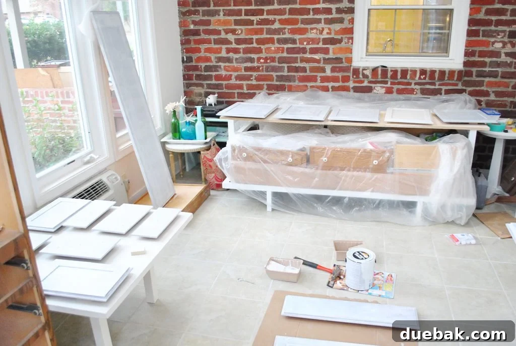 Cabinet Doors Get Painted In Sunroom On Paint Risers