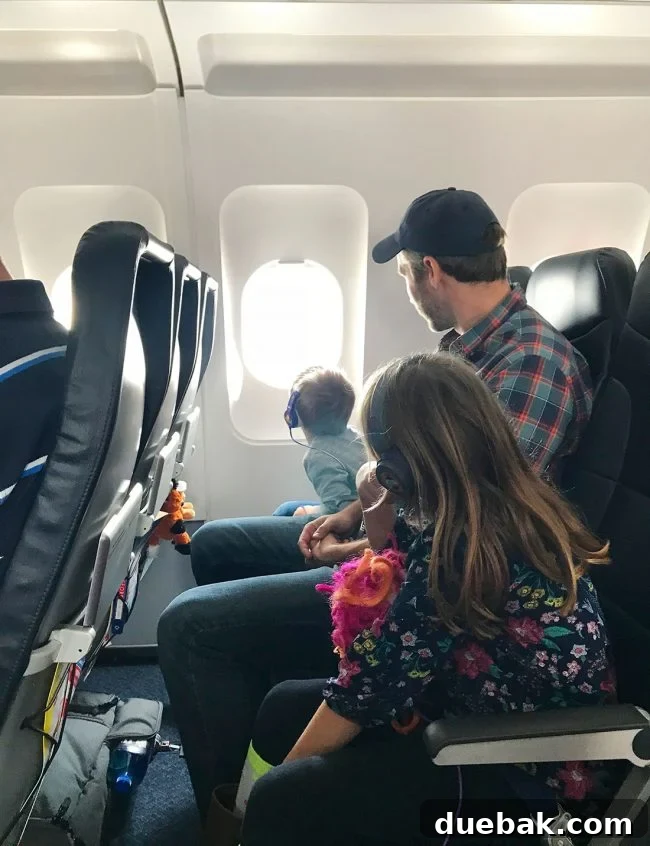 John and kids on plane to spring break in florida