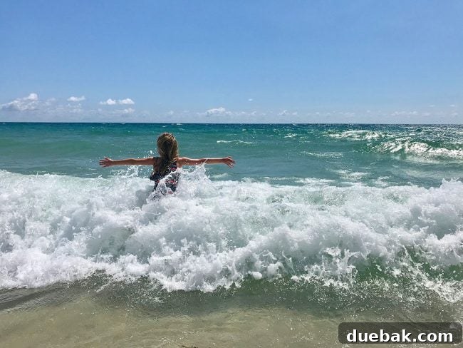 little girl playing in waves during Spring Break in Lauderdale By The Sea Florida