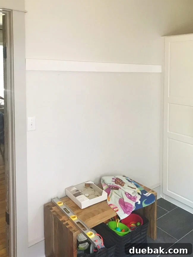 white board hung on wall in mudroom