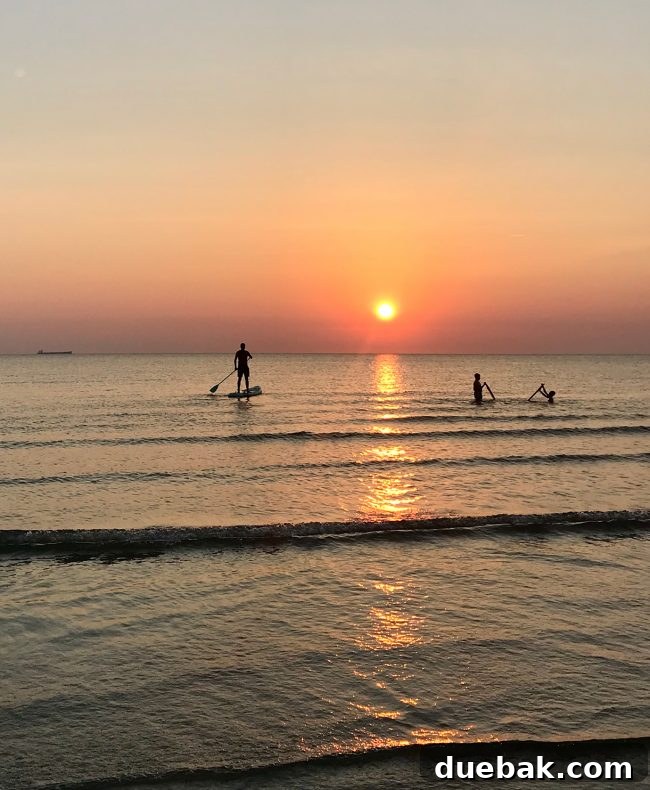 Inflatable stand-up paddleboard at sunset