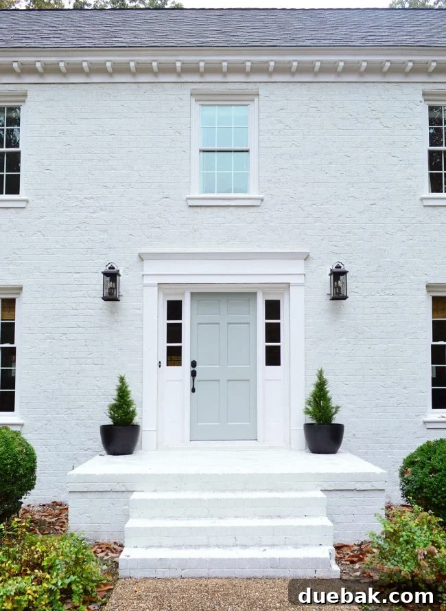 How We Transformed Our Brick House with White Paint 23 after of brick house front porch with new trim and painted front door