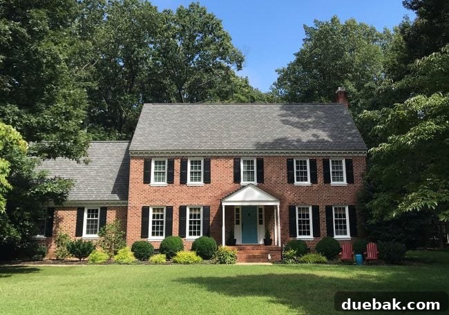 How We Transformed Our Brick House with White Paint 10 before photo of brick house with black shutters to be painted white