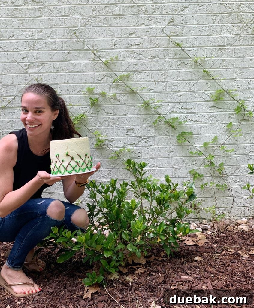 Sherry posing next to wire trellis with vine decorated cake