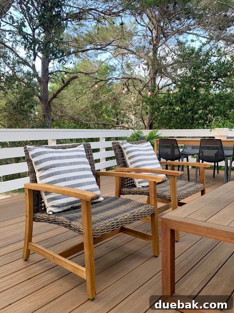 Two Woven And Wood Outdoor Lounge Chairs With Large Striped Pillows