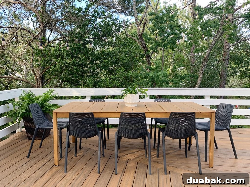 Metal Outdoor Dining Table With Eight Black Plastic Chairs