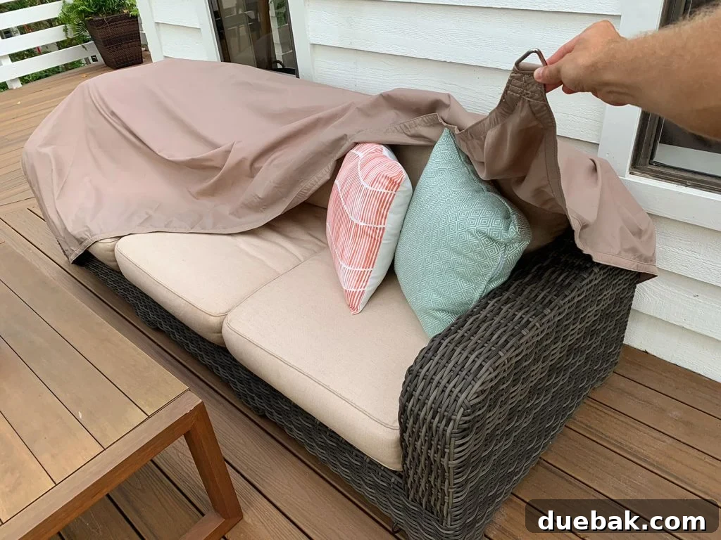 Waterproof Sail Shade Cover Being Pulled Over Outdoor Couch