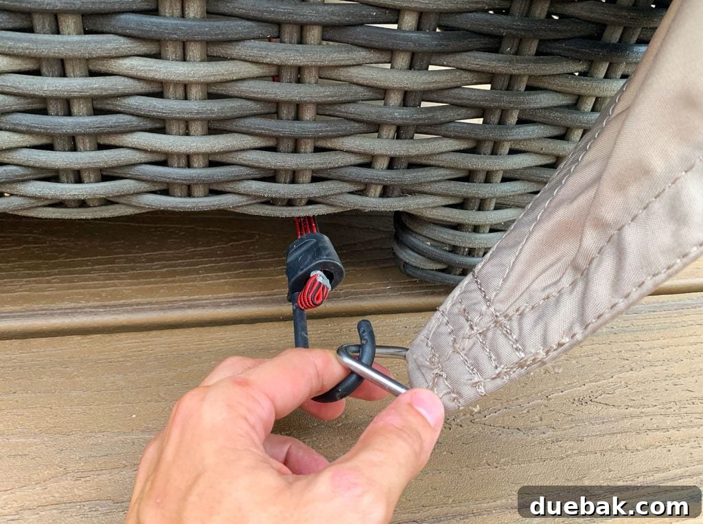 Close Up Of Bungee Hook Looping Over Ring On Sun Sail Cover