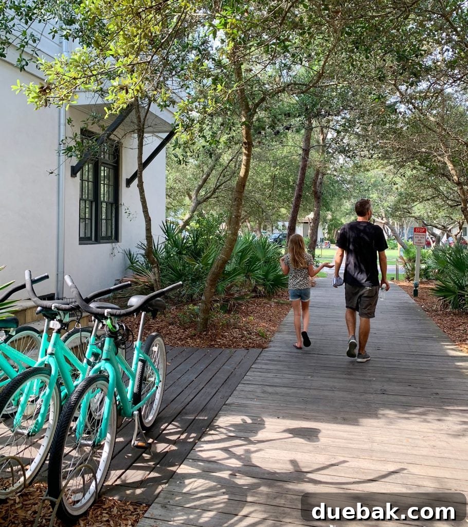 John and daughter walking on wooded walkway next to bikes