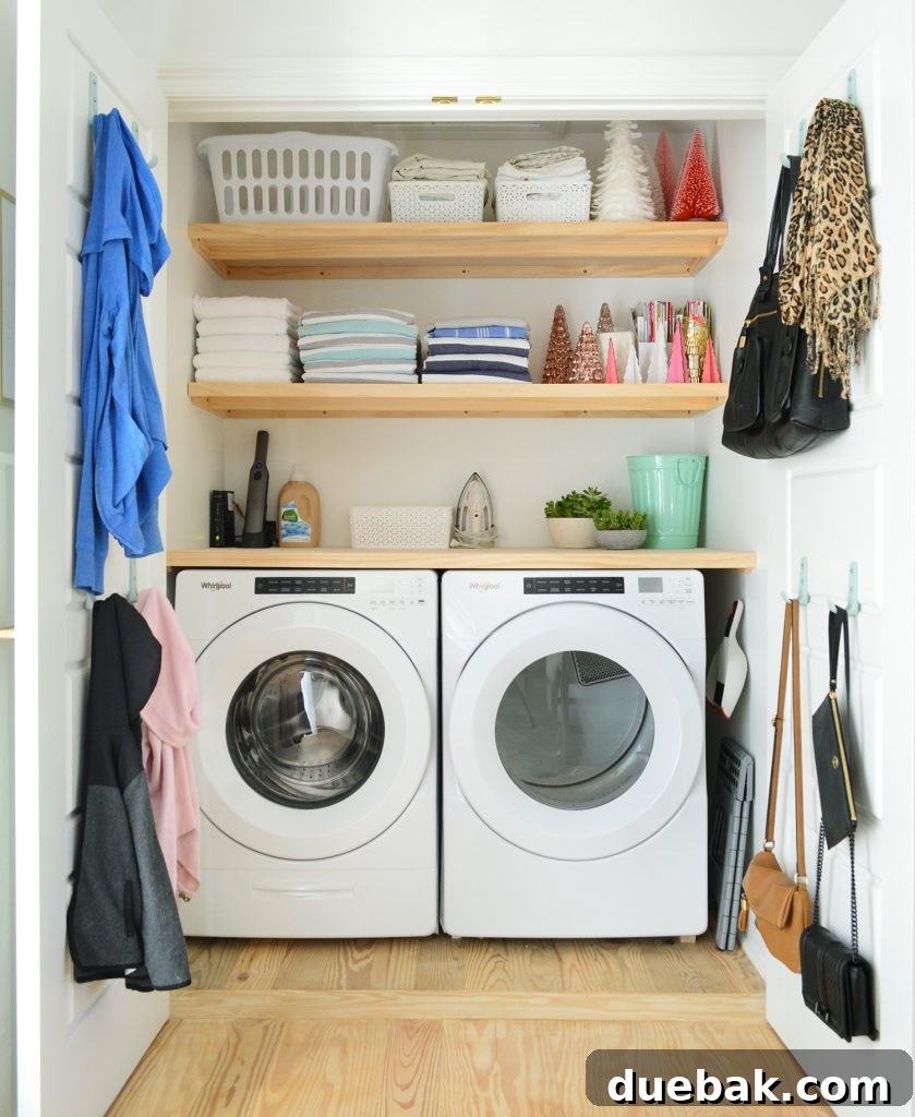 Front loading laundry appliances in closet with wood shelves on top