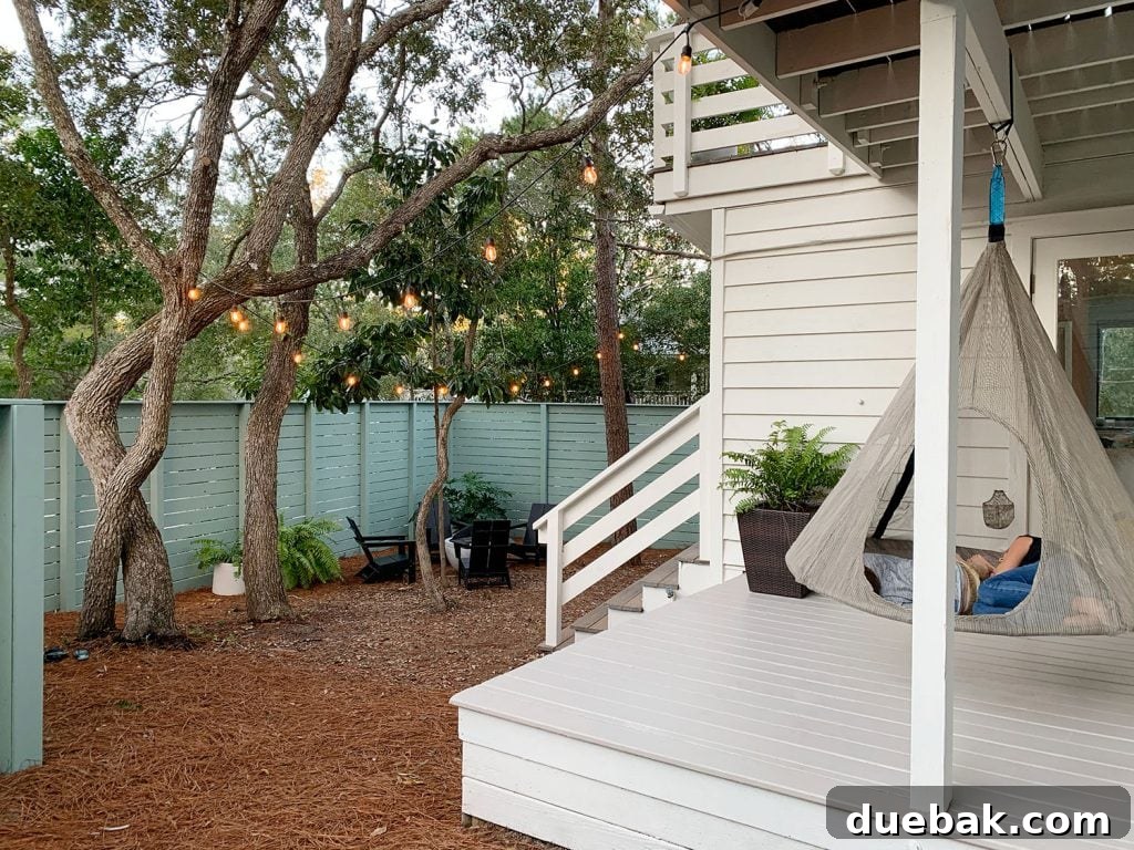 How to Paint a Porch Floor: Step-by-Step Guide for Lasting Results 12 Two kids laying in hanging tent on covered porch with green painted fence in background