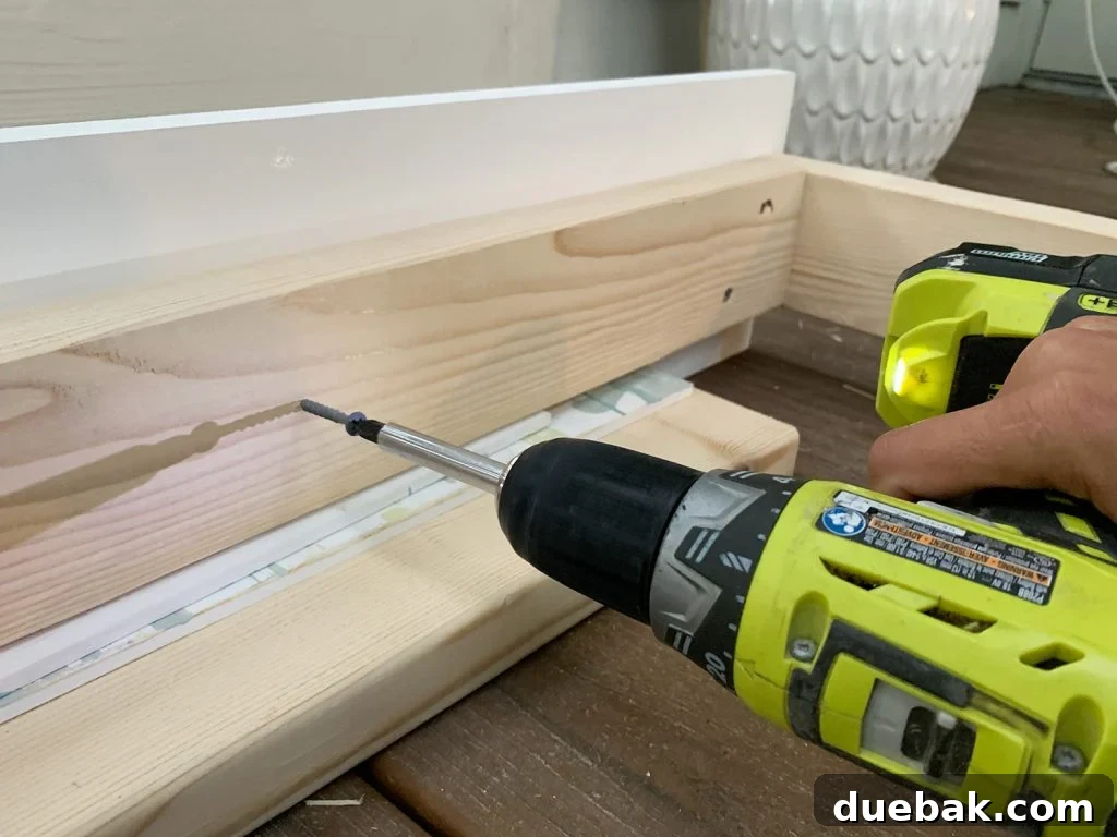 Screwing 2x4 wood frame to white 1x8 board