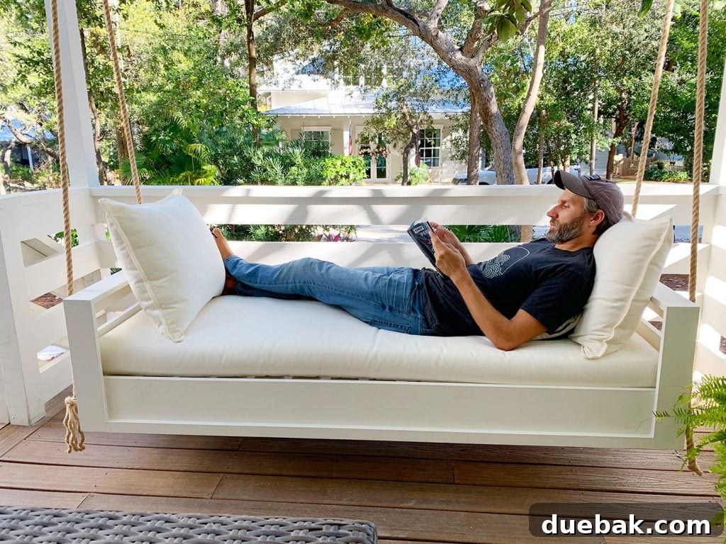John Laying Fully Stretched Out On Hanging Daybed Swing
