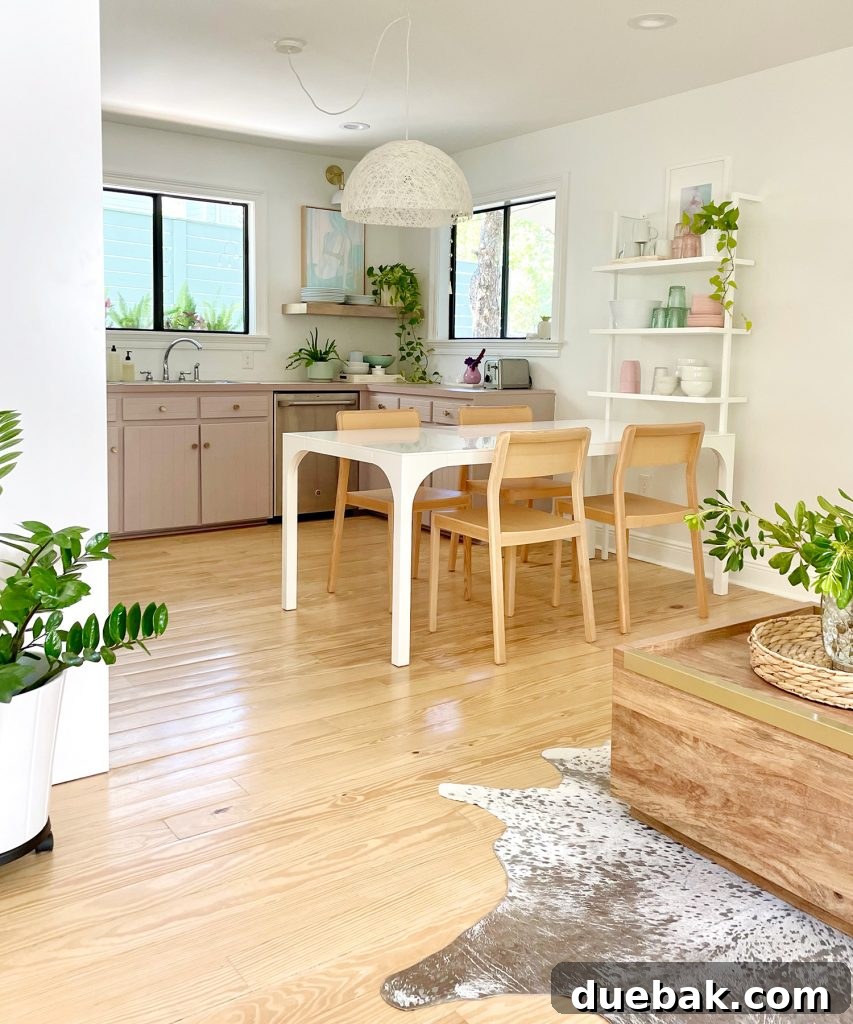 Vertical View Of Walking Space To Beachy Kitchen With Wood Furniture And Mauve Cabinets
